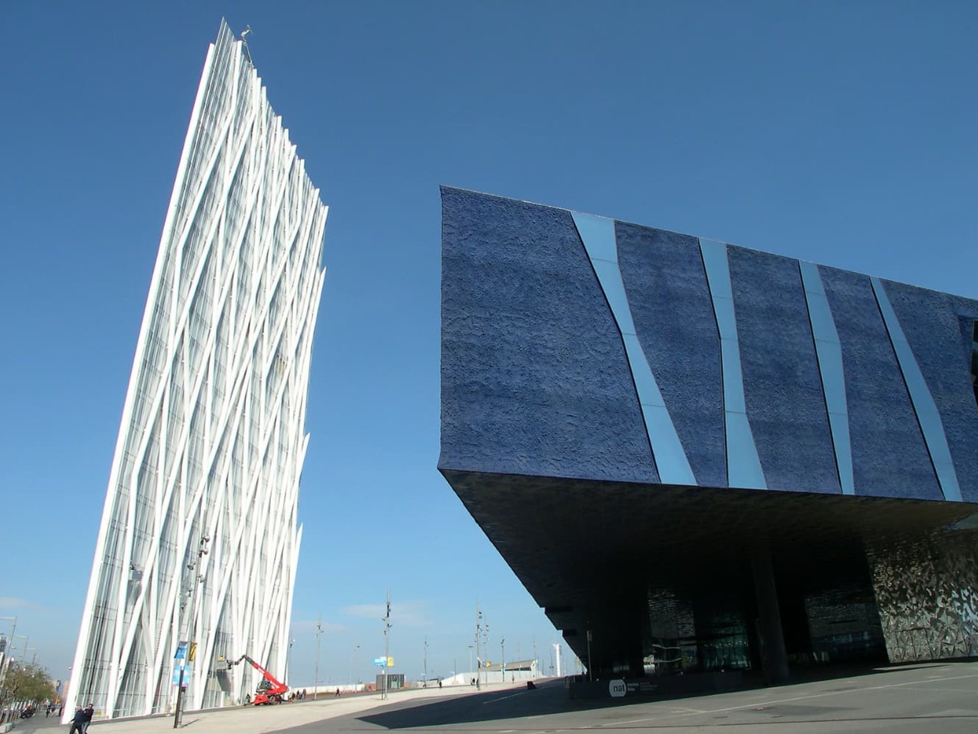 an abstract photo of a curved building with a blue sky in the background